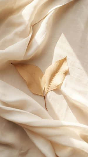 Beige Leaf On Textured Fabric.jpg Wallpaper