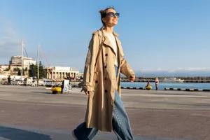 Beige Trench Coat Woman Walking Seaside Wallpaper