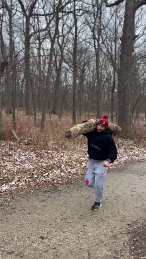 Belal Muhammad Carrying Wood Log Wallpaper