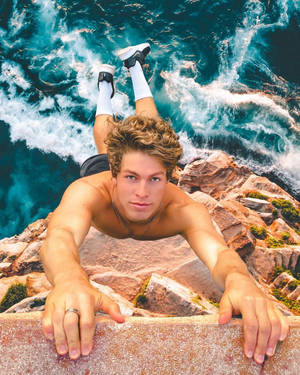 Ben Azelart Hanging On The Cliff Wallpaper