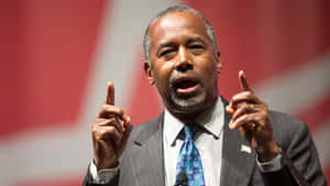 Ben Carson Emphasizing Point With Hand Gestures Wallpaper