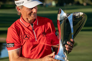 Bernhard Langer Looking At His Trophy Wallpaper