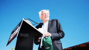 Bernie Sanders Speakingat Podium Outdoors Wallpaper