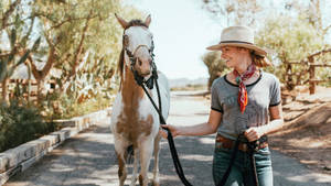 Beth Behrs With A Horse Wallpaper