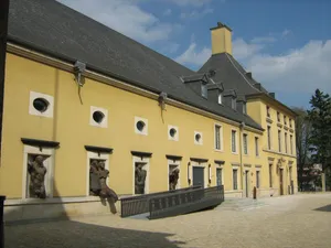 Bettembourg Yellow Buildingwith Sculptures Wallpaper