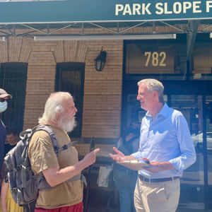 Bill De Blasio Conversing With A Man Wallpaper