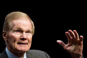 Bill Nelson Raises Hand With Black Backdrop Wallpaper