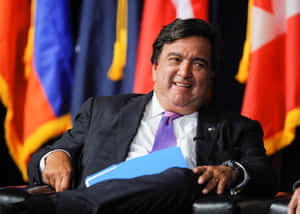 Bill Richardson Smiling And Sitting Down Wallpaper