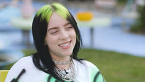 Billie Eilish Smiling To Her Fans Wallpaper