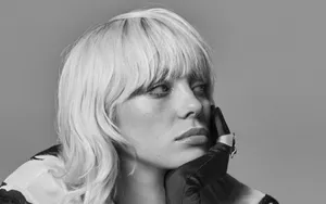 Billie Eilish Stands With Her Laptop, Making Music. Wallpaper