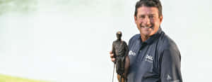 Billy Andrade Holding A Golf Trophy Wallpaper