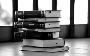 Black And White Book On A Wooden Table Wallpaper