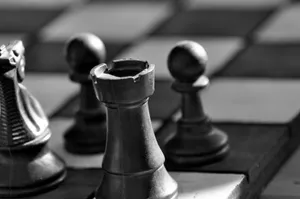 Black And White Chess Battle On Classic Board Wallpaper