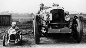 Black And White Vintage Car On A Classic Road Wallpaper