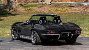 Black Chevrolet Corvette Convertible Parked Outdoors Wallpaper