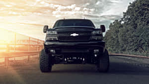 Black Chevrolet Truck Dominating Road Wallpaper