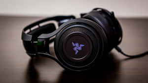 Black Gaming Headphoneson Desk Wallpaper