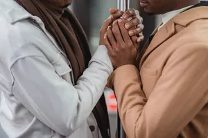 Black Gay Man Wearing A White Suit Wallpaper