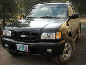 Black Isuzu Rodeo S U V Parked Outdoors Wallpaper
