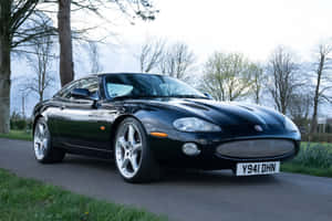 Black Jaguar X K Coupe Parked Outdoors Wallpaper
