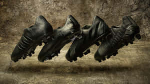 Black Soccer Cleats Artistic Display Wallpaper