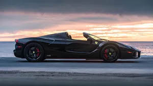 Black Sports Car Sunset Backdrop Wallpaper