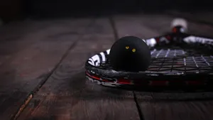 Black Squash Racket And Ball Wallpaper