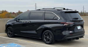 Black Toyota Sienna Parked Outdoors Wallpaper