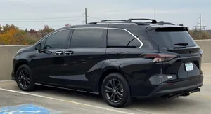 Black Toyota Sienna Parked Outdoors Wallpaper