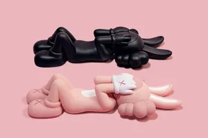 Blackand Pink Kaws Figures Lying Down Wallpaper