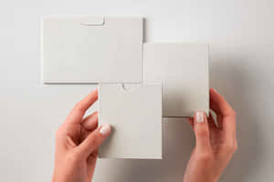 Blank Packaging Mockup Held By Hand Wallpaper