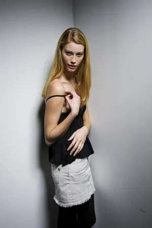 Blonde Modelin Black Topand White Skirt Wallpaper