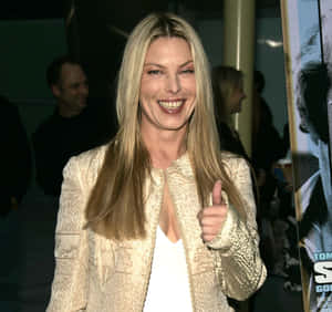 Blonde Woman Giving Thumbs Upat Event Wallpaper