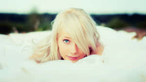 Blonde Woman Lyingin White Bedding Wallpaper