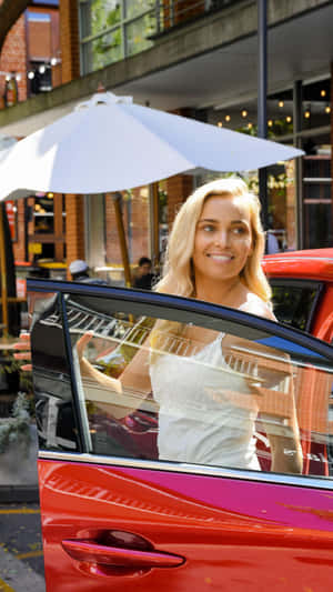 Blonde Woman Smiling Near Car With Umbrella Wallpaper