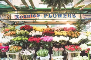 Blooming Flowers At A Colorful Market Wallpaper