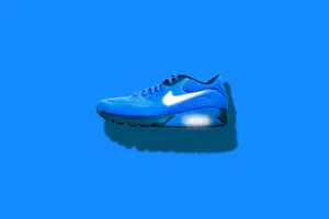 Blue Athletic Sneakeron Blue Background.jpg Wallpaper