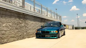 Blue B M W E36 Coupe Racetrack Side View Wallpaper