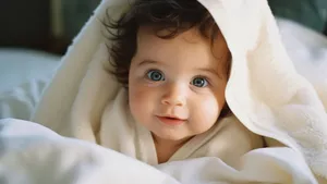 Blue Eyed Baby Peeking From Blanket Wallpaper