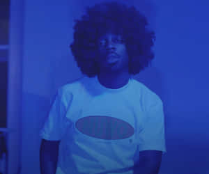 Blue Hued Portrait Of Man With Afro Wallpaper