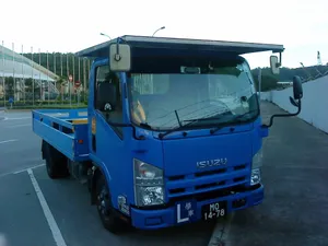 Blue Isuzu Elf Truck Parked Wallpaper