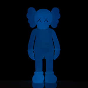 Blue Kaws Figure Standing Against Black Background Wallpaper