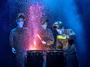 Blue Man Group Performing On Stage Wallpaper