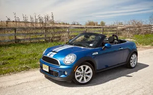 Blue Mini Roadster Convertible Parked Outdoors Wallpaper