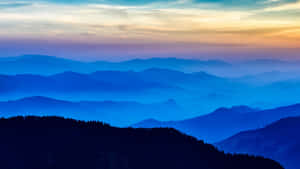 Blue Mountain Silhouettesat Sunset Wallpaper