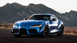 Blue Toyota Supra Near Terrains Wallpaper