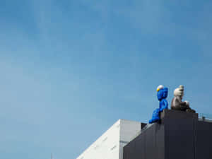 Blueand Grey Kaws Sculptureson Building Wallpaper