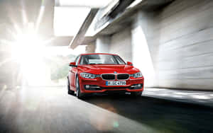 Bmw 3 Series - A Red Car Driving Down A Road Wallpaper