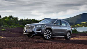 Bmw X1 Parked In Majestic Landscape Wallpaper