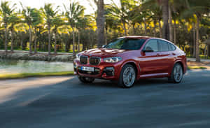 Bmw X4 Gliding On An Open Road Wallpaper